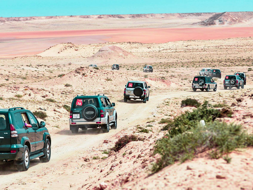 a convoy of cars in the desert of dakhla